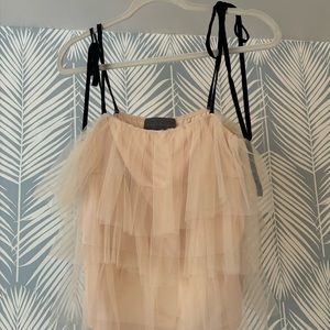 cream tiered tank with adjustable black ties .